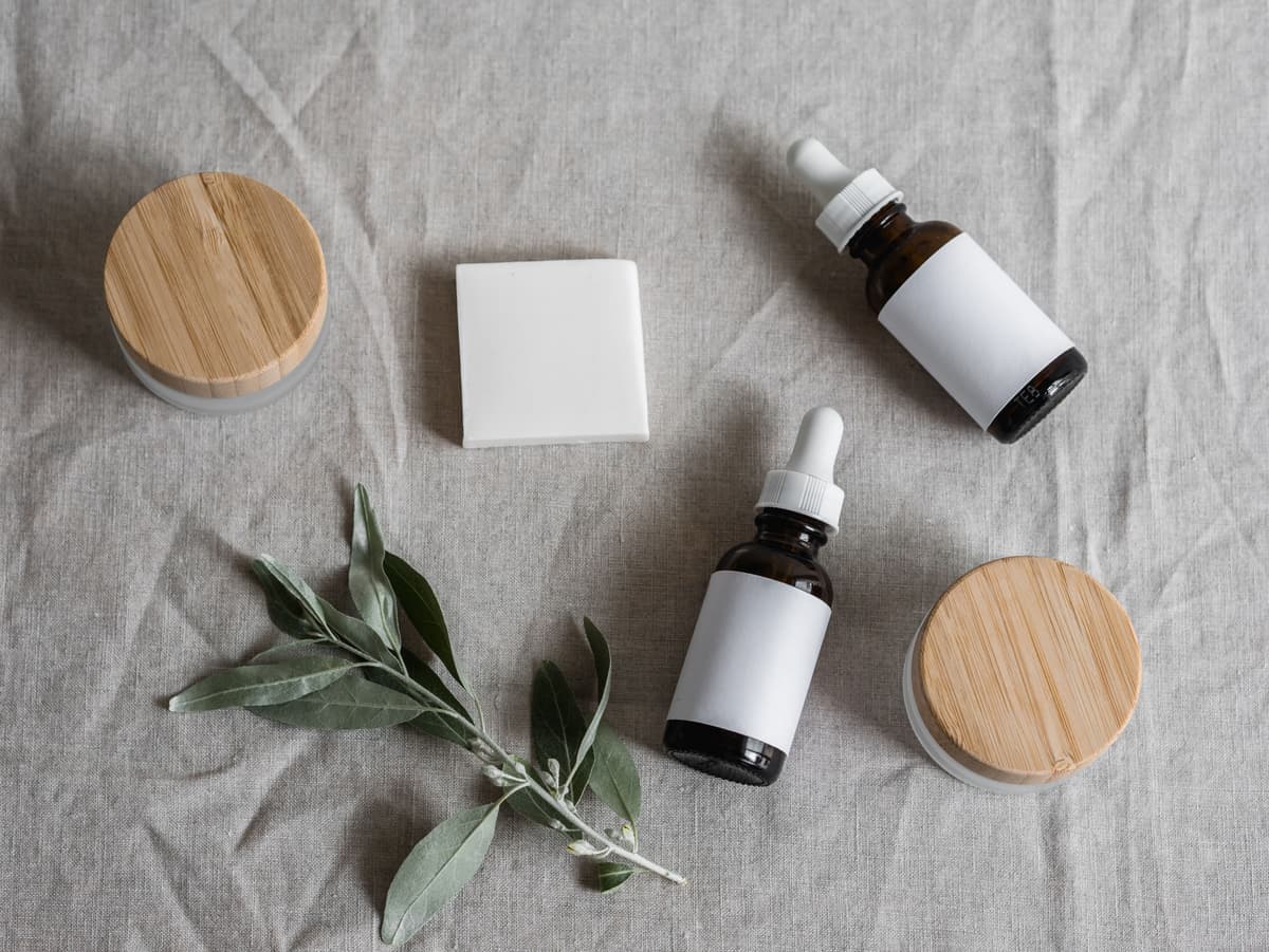 Skincare ingredients and tools arranged on warm linen, apothecary-style